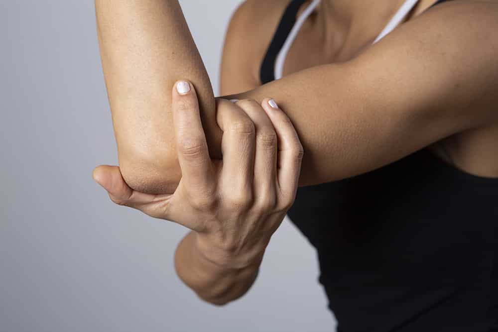 woman tennis elbow pain